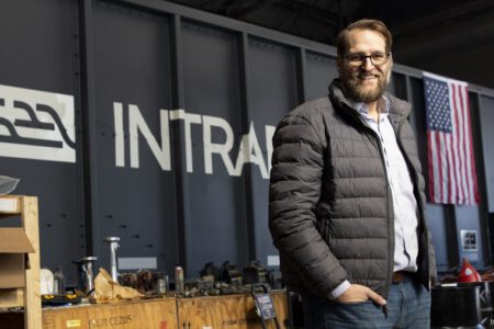 Tim Luchini in front of a self-driving railcar