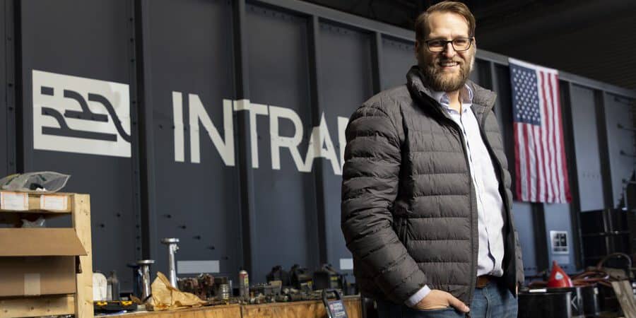 Tim Luchini in front of a self-driving railcar